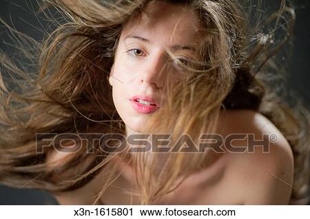 Stock Image - Woman with wild hair flying about. Fotosearch
