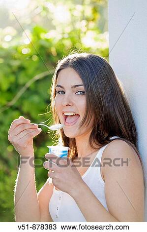 Woman with yogurt looking at camera View Large Photo Image Stock Image - Woman with yogurt looking at camera. Fotosearch