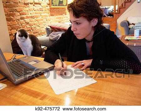 Stock Image - Woman working at home on a laptop. Fotosearch