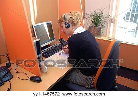 Woman working in callcentre, using a computer and a headset. View Large Photo Image Stock Image - Woman working in callcentre, using a computer and a headset.. Fotosearch