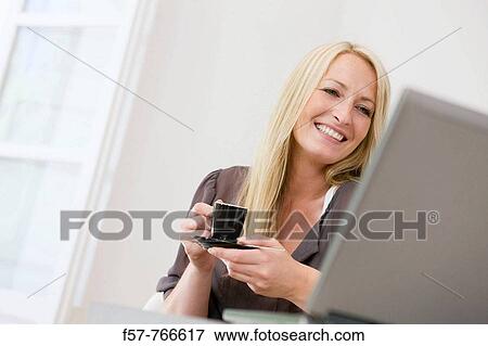 Woman working on laptop at home View Large Photo Image Stock Photo - Woman working on laptop at home. Fotosearch