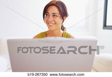 Stock Image - Woman working with a portable computer. Fotosearch