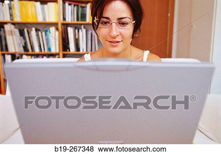 Woman working with a portable computer View Large Photo Image Stock Photo - Woman working with a portable computer. Fotosearch