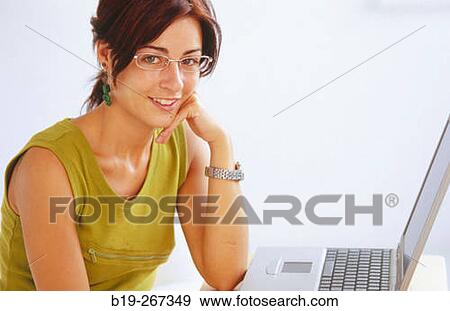 Stock Photo - Woman working with a portable computer. Fotosearch
