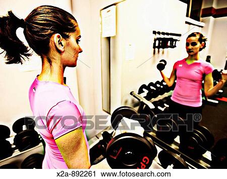 WOMAN WORKOUT LIFTING WEIGHTS DUMBELLS View Large Photo Image Stock Image - WOMAN WORKOUT LIFTING WEIGHTS DUMBELLS. Fotosearch