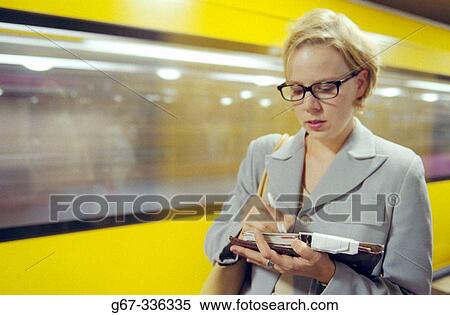 Woman writing in an organiser. Berlin. Germany. View Large Photo Image Stock Photography - Woman writing in an organiser. Berlin. Germany.. Fotosearch