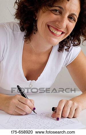 Stock Image - Woman writing. Fotosearch