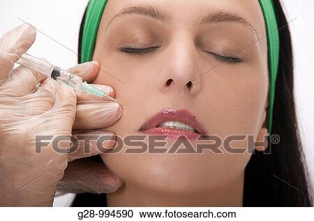 woman's face with doctor's hands giving a botox injection for a face lifting View Large Photo Image Stock Image - woman's face with doctor's hands giving a botox injection for a face lifting. Fotosearch