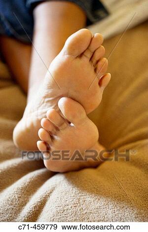 Woman's feet in bed View Large Photo Image Stock Photo - Woman's feet in bed. Fotosearch