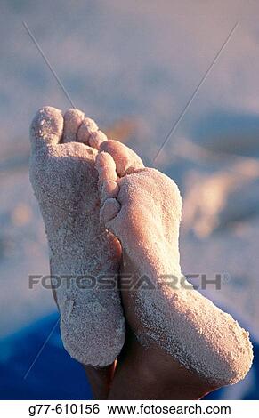 Stock Photograph - Woman's feet on beach. Fotosearch