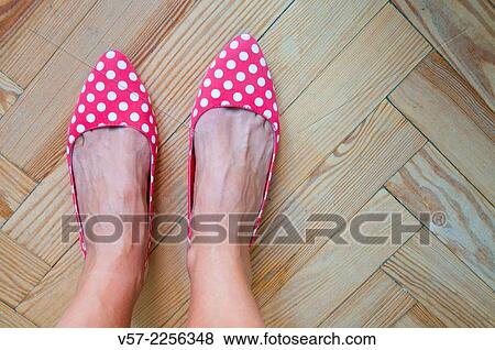 Woman's feet wearing red shoes with white polka dots. Close view. View Large Photo Image Stock Photo - Woman's feet wearing red shoes with white polka dots. Close view.. Fotosearch