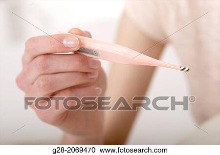 Woman's hand holding a pink medical thermometer, close up, detail symbol View Large Photo Image Stock Image - Woman's hand holding a pink medical thermometer, close up, detail symbol. Fotosearch