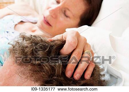 Stock Photo - Woman's hand on man's head. Fotosearch