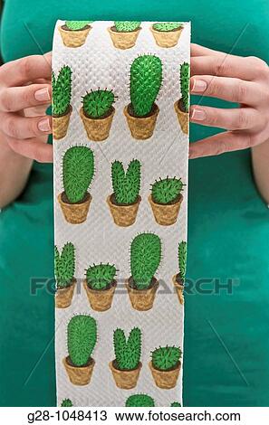 woman's hands holding a roll of toilet paper printed with green cactuses to express toilet difficulties View Large Photo Image Stock Image - woman's hands holding a roll of toilet paper printed with green cactuses to express toilet difficulties. Fotosearch