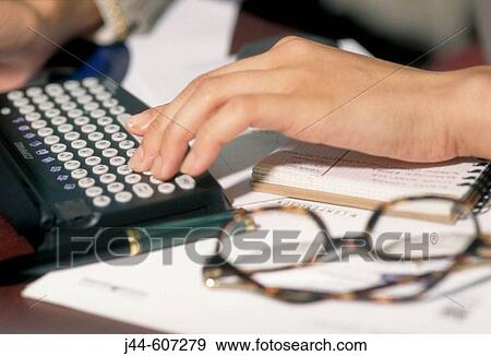 Stock Photo - Woman's hands on an electronic organizer. Fotosearch
