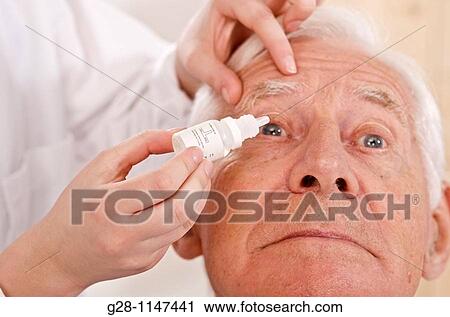 woman's hands putting eye drops into senior man eyes View Large Photo Image Stock Image - woman's hands putting eye drops into senior man eyes. Fotosearch