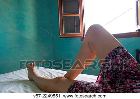 Woman's legs lying on bed. Close view. View Large Photo Image Stock Image - Woman's legs lying on bed. Close view.. Fotosearch