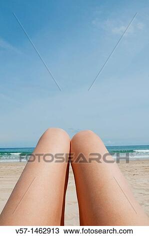 Woman's legs lying on the beach. Close view. View Large Photo Image Stock Image - Woman's legs lying on the beach. Close view.. Fotosearch
