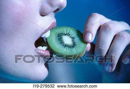 womans mouth eating kiwi fruit View Large Photo Image Stock Image - womans mouth eating kiwi fruit. Fotosearch