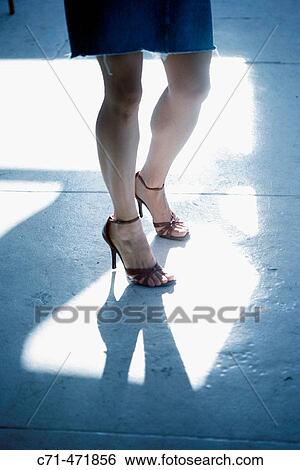 Womans sexy legs in highlight View Large Photo Image Stock Photograph - Womans sexy legs in highlight. Fotosearch