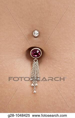 Stock Photography - woman's tummy pierced with jewel, detail. Fotosearch