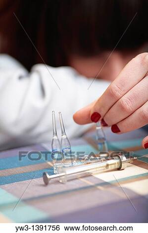 women and drags syringe on the table View Large Photo Image Stock Photograph - women and drags syringe on the table. Fotosearch