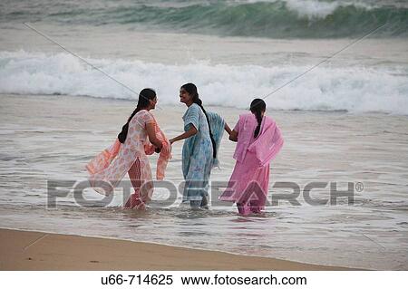 Women bathing at Lighthouse beach, Kerala, India View Large Photo Image Stock Photography - Women bathing at Lighthouse beach, Kerala, India. Fotosearch