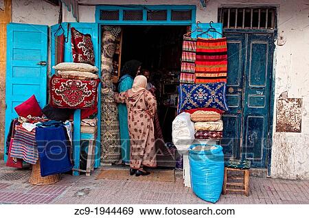 Women buying in a shop. Essaouira medina, Morocco. View Large Photo Image Stock Photo - Women buying in a shop. Essaouira medina, Morocco.. Fotosearch