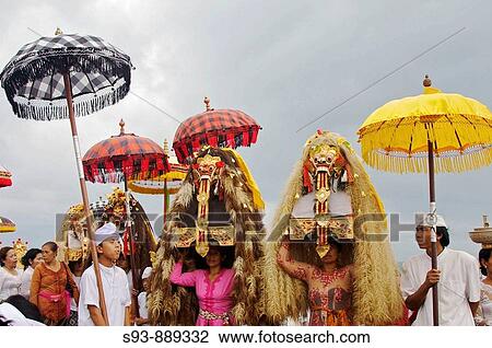 Women carrying demon masks on platfroms on their heads with Balinese umbrellas behind. View Large Photo Image Stock Image - Women carrying demon masks on platfroms on their heads with Balinese umbrellas behind.. Fotosearch