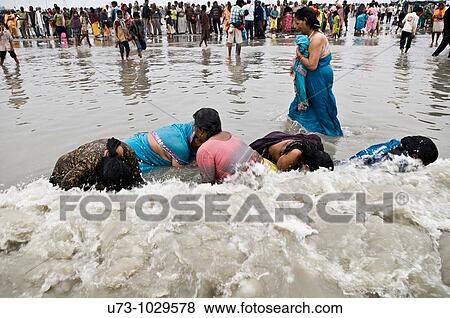 Women dip in the holy water of Gangasagar island during the annual Gangasagar mela. View Large Photo Image Stock Photo - Women dip in the holy water of Gangasagar island during the annual Gangasagar mela.. Fotosearch