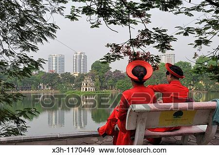 Stock Photo - women dressed with traditional costume, Hoen Kiem lake, Hanoi, Northern Vietnam, southeast asia. Fotosearch