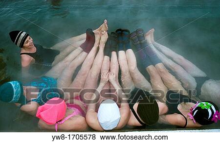 Stock Photo - Women enjoying a geothermal heated hot tub outside in the winter, Iceland. Fotosearch