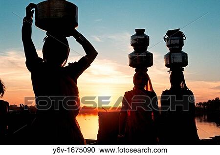 Women fetching water at sunset Gujarat, India View Large Photo Image Stock Image - Women fetching water at sunset Gujarat, India. Fotosearch