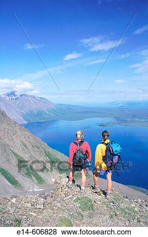 Women hiking on King's Throne mountain, overlooking Kathleen Lake. Kluane National Park. Canada View Large Photo Image Stock Photo - Women hiking on King's Throne mountain, overlooking Kathleen Lake. Kluane National Park. Canada. Fotosearch