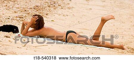 women in bikini sunbathig on the beach View Large Photo Image Stock Photo - women in bikini sunbathig on the beach. Fotosearch