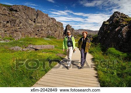 Stock Photo - women in Rift Valley. Pingvellir National Park. Golden Circle. Iceland, Europe.. Fotosearch