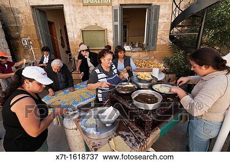 Women in the village of Proastio making diples, fried, sweet pasties, in preparation for a religious festival, Outer Mani, Peloponnese, Greece View Large Photo Image Stock Photo - Women in the village of Proastio making diples, fried, sweet pasties, in preparation for a religious festival, Outer Mani, Peloponnese, Greece. Fotosearch