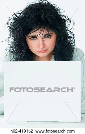 Women managers, worried looks from behind her laptop View Large Photo Image Stock Image - Women managers, worried looks from behind her laptop. Fotosearch