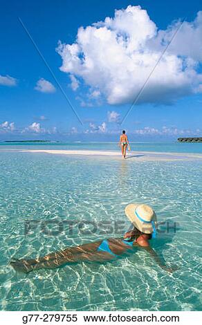 Stock Photography - Women on the beach in White Sands Resort and Spa. Ari Atoll. Maldives. Fotosearch