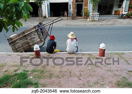 Women on the Sidewalk in Phnom Penh, Cambodia. View Large Photo Image Stock Photograph - Women on the Sidewalk in Phnom Penh, Cambodia.. Fotosearch