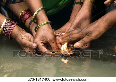 Women perform a puja ceremony at the Ganges river. View Large Photo Image Stock Image - Women perform a puja ceremony at the Ganges river.. Fotosearch