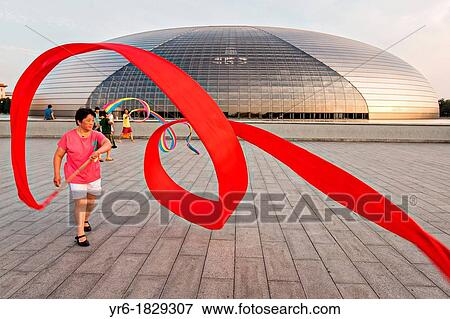 Stock Photo - Women practice ribbon dancing at the National Centre for Performing Arts park in Beijing, China. Fotosearch