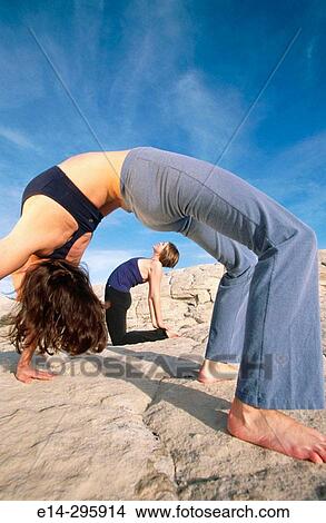 Women practicing yoga at Snow Canyon State Park. Utah, USA View Large Photo Image Picture - Women practicing yoga at Snow Canyon State Park. Utah, USA. Fotosearch