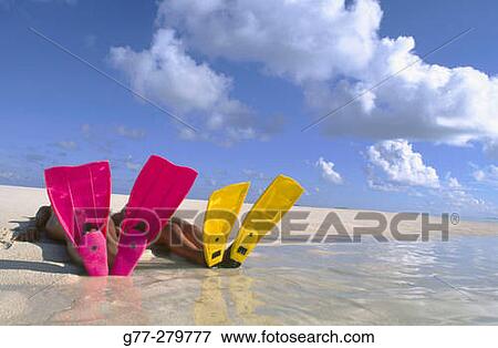 Stock Photo - Women resting on a beach in Ari Atoll. Maldives. Fotosearch