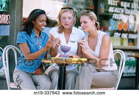 Women sharing an ice cream View Large Photo Image Stock Image - Women sharing an ice cream. Fotosearch