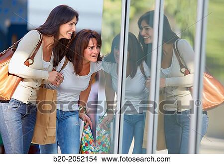 Women sisters 35 and 40 years looking a shop window. Shopping on the street. Donostia. San Sebastian. Gipuzkoa. Basque Country- Spain. View Large Photo Image Picture - Women sisters 35 and 40 years looking a shop window. Shopping on the street. Donostia. San Sebastian. Gipuzkoa. Basque Country- Spain.. Fotosearch