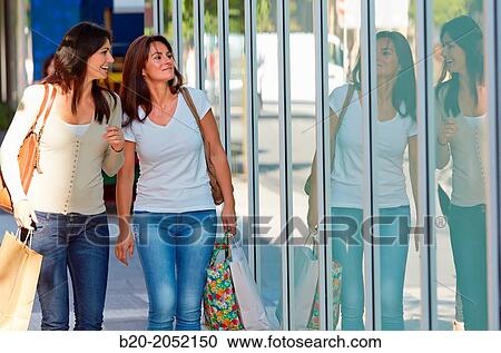 Women sisters 35 and 40 years looking a shop window. Shopping on the street. Donostia. San Sebastian. Gipuzkoa. Basque Country- Spain. View Large Photo Image Stock Image - Women sisters 35 and 40 years looking a shop window. Shopping on the street. Donostia. San Sebastian. Gipuzkoa. Basque Country- Spain.. Fotosearch