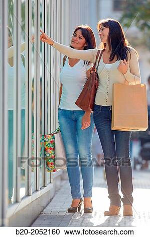 Women sisters 35 and 40 years looking a shop window. Shopping on the street. Donostia. San Sebastian. Gipuzkoa. Basque Country- Spain. View Large Photo Image Stock Image - Women sisters 35 and 40 years looking a shop window. Shopping on the street. Donostia. San Sebastian. Gipuzkoa. Basque Country- Spain.. Fotosearch