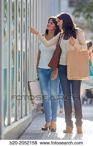 Women sisters 35 and 40 years looking a shop window. Shopping on the street. Donostia. San Sebastian. Gipuzkoa. Basque Country- Spain. View Large Photo Image Stock Photo - Women sisters 35 and 40 years looking a shop window. Shopping on the street. Donostia. San Sebastian. Gipuzkoa. Basque Country- Spain.. Fotosearch