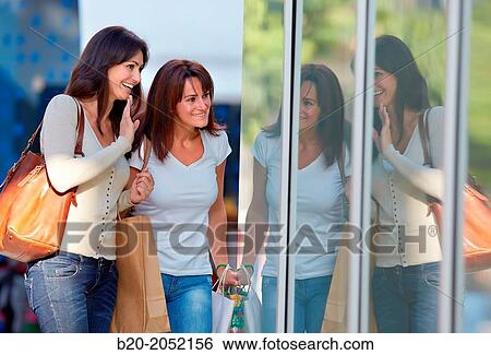 Women sisters 35 and 40 years looking a shop window. Shopping on the street. Donostia. San Sebastian. Gipuzkoa. Basque Country- Spain. View Large Photo Image Stock Photograph - Women sisters 35 and 40 years looking a shop window. Shopping on the street. Donostia. San Sebastian. Gipuzkoa. Basque Country- Spain.. Fotosearch